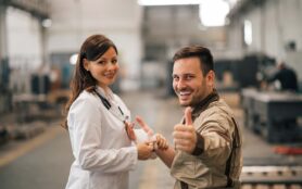 Portrait,Of,Injured,Worker,Showing,Thumbs Up,While,Getting,Treated,By
